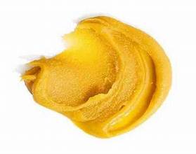 Close-up of Badder concentrate with a golden, waxy texture, showing its high THC content of 90-96%. This potent cannabis concentrate offers a rich, aromatic experience and is ideal for users seeking strong effects and a smooth, flavorful experience.